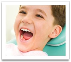 Young boy in exam chair with his mouth open wide